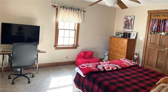 bedroom with a textured ceiling, ceiling fan, and baseboards