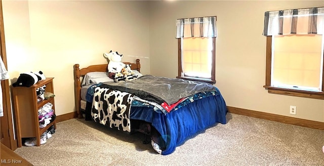 carpeted bedroom featuring baseboards