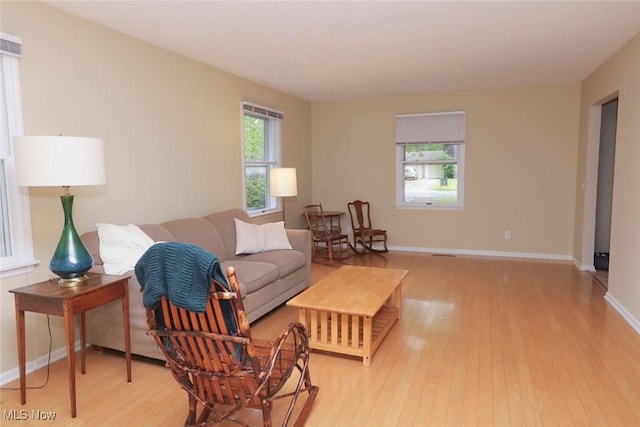 living room featuring light wood-type flooring and baseboards