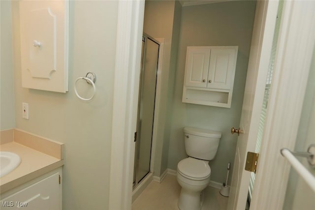 bathroom featuring baseboards, toilet, a shower stall, and vanity