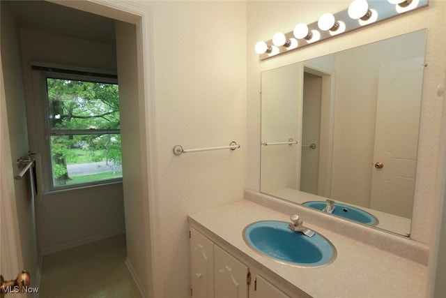 bathroom featuring baseboards and vanity