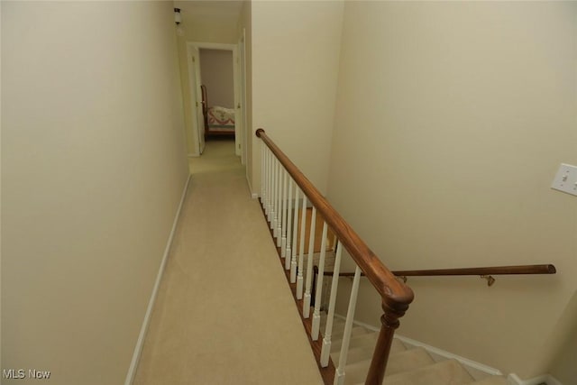 staircase with carpet flooring and baseboards