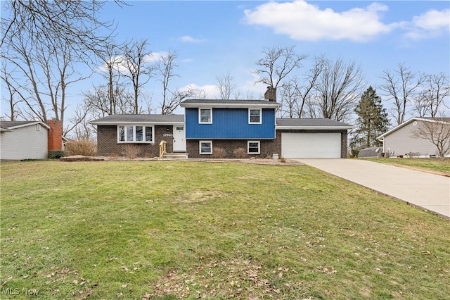 split level home with an attached garage, brick siding, concrete driveway, a front lawn, and a chimney