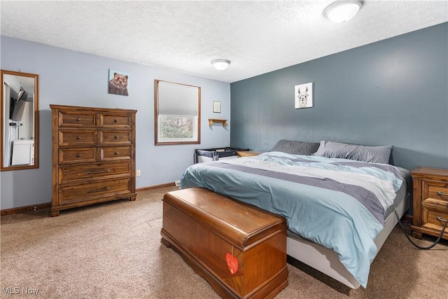 bedroom featuring a textured ceiling, carpet, and baseboards