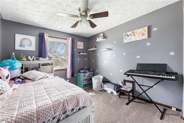 carpeted bedroom featuring a ceiling fan and a textured ceiling