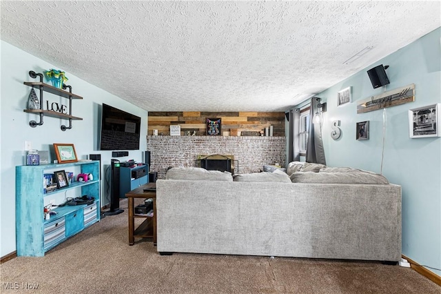 carpeted living area featuring baseboards, a fireplace, wooden walls, and a textured ceiling