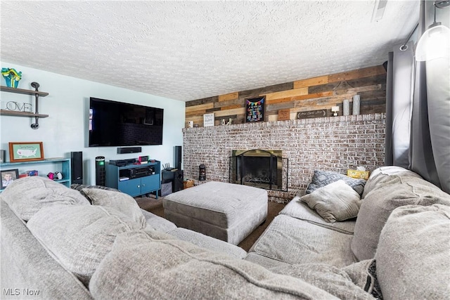 living area featuring a fireplace, wood walls, and a textured ceiling