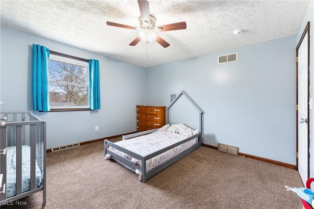 bedroom featuring carpet floors, visible vents, and baseboards