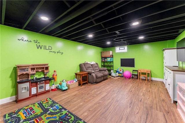 game room featuring baseboards and wood finished floors