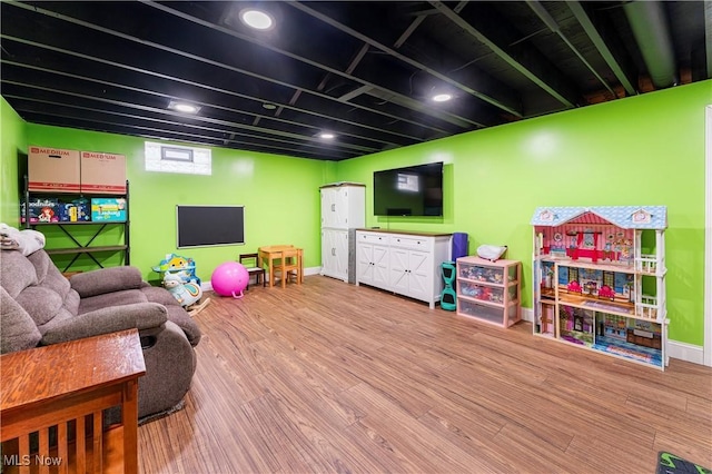 rec room with baseboards and wood finished floors