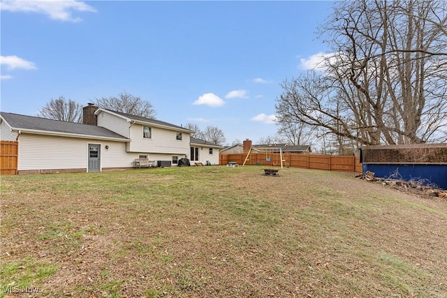 view of yard featuring an outdoor fire pit and a fenced backyard