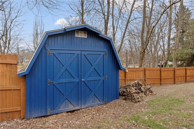 view of shed featuring fence