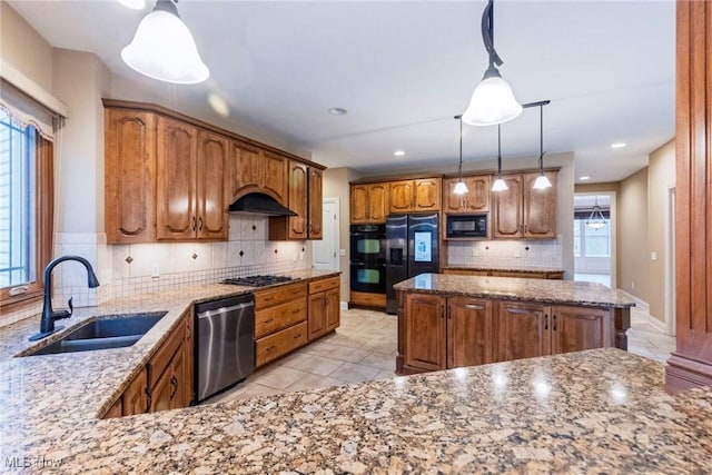 kitchen with black appliances, light stone counters, decorative backsplash, and a sink