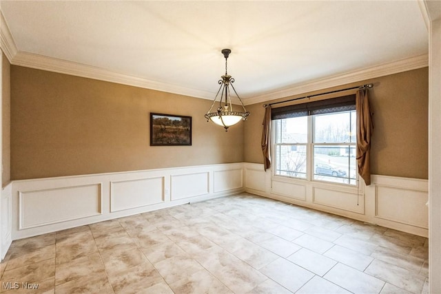 unfurnished dining area with a wainscoted wall and crown molding