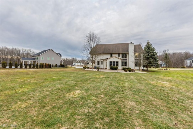 rear view of house with a yard