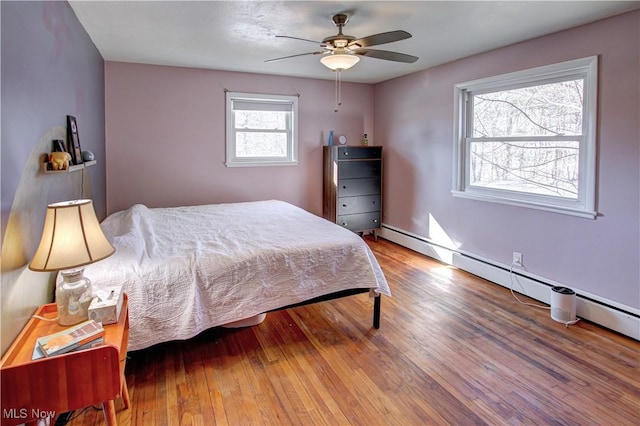 bedroom featuring hardwood / wood-style flooring and ceiling fan