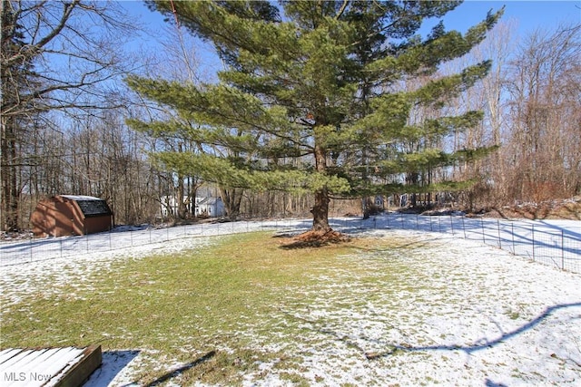 snowy yard with an outdoor structure