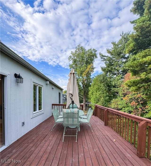 wooden deck featuring outdoor dining space