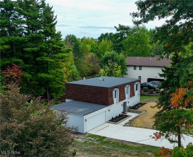 view of front facade featuring concrete driveway and a garage