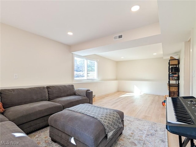 living area with recessed lighting, visible vents, and light wood-style flooring