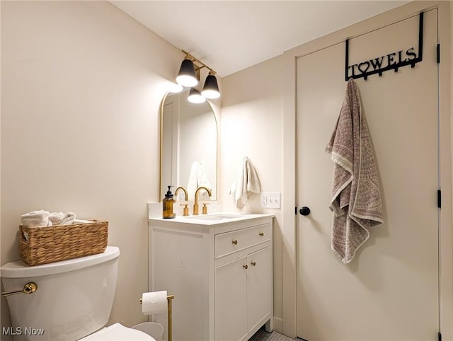 bathroom with toilet and vanity