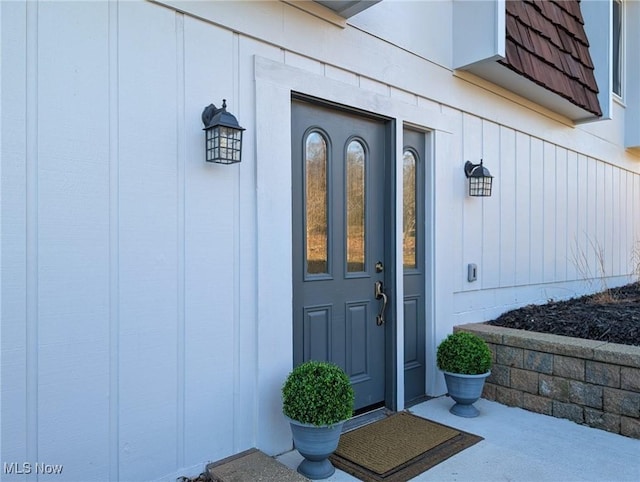 doorway to property featuring mansard roof