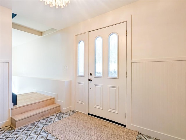 entryway with a chandelier