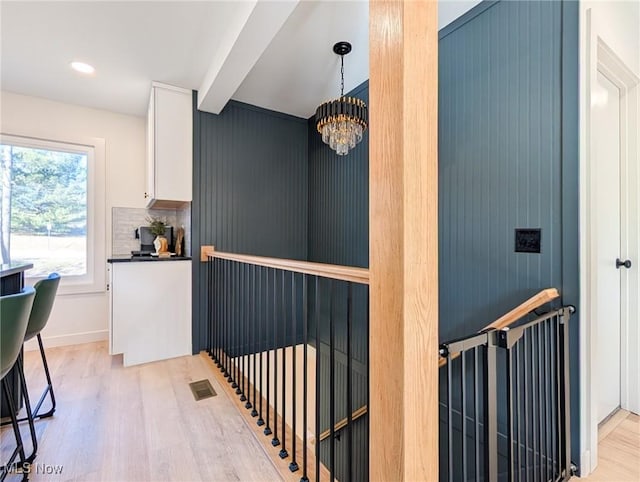 interior space featuring light wood finished floors, visible vents, baseboards, beam ceiling, and recessed lighting