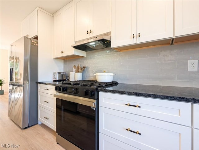 kitchen featuring under cabinet range hood, tasteful backsplash, gas stove, white cabinets, and stainless steel fridge with ice dispenser