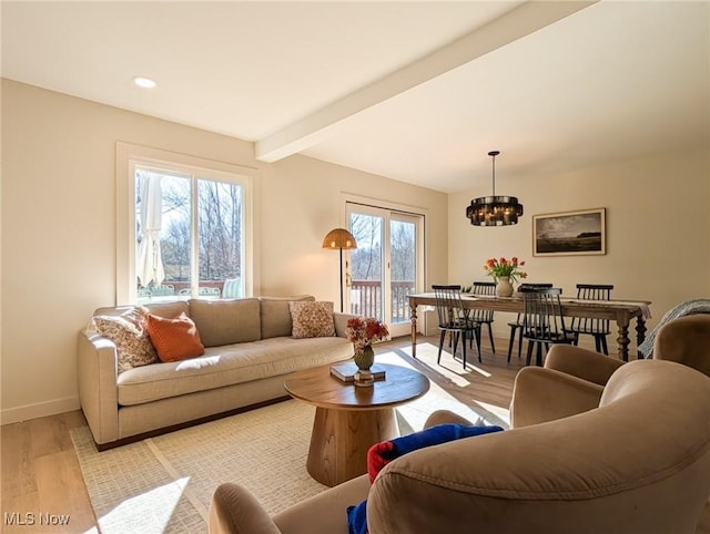 living room with beamed ceiling, a notable chandelier, recessed lighting, light wood finished floors, and baseboards