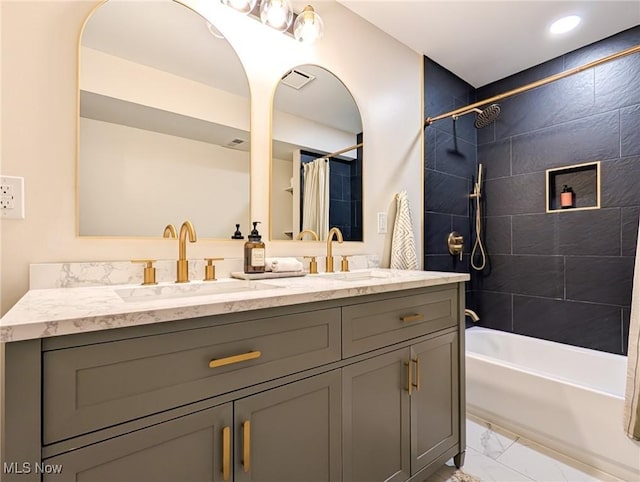 full bathroom featuring visible vents, marble finish floor, shower / tub combo with curtain, and a sink