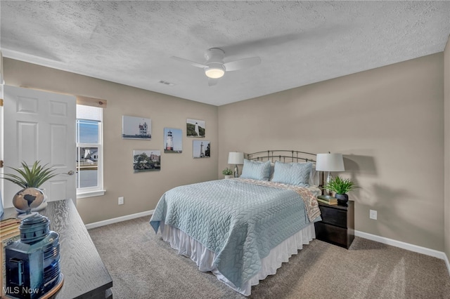 carpeted bedroom with a ceiling fan, baseboards, and a textured ceiling