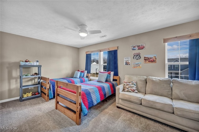 bedroom featuring visible vents, a textured ceiling, and carpet flooring