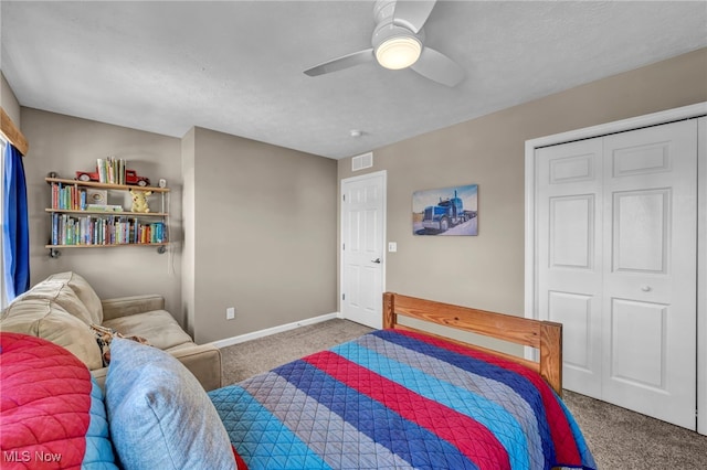 carpeted bedroom featuring ceiling fan, a closet, visible vents, and baseboards