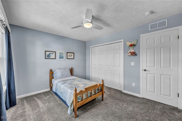 carpeted bedroom featuring a textured ceiling, a ceiling fan, visible vents, baseboards, and a closet