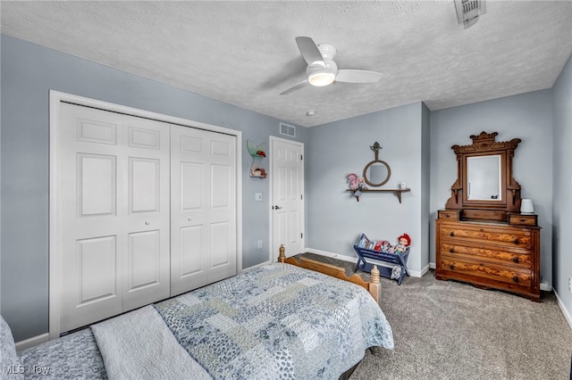 bedroom featuring a textured ceiling, a closet, and baseboards