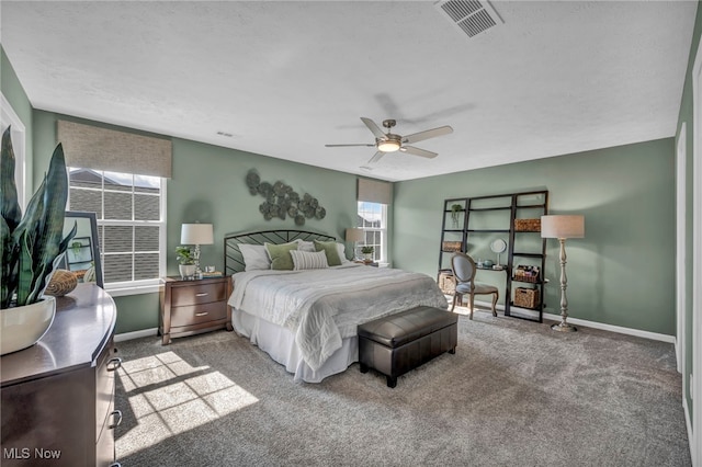 bedroom featuring a ceiling fan, carpet, visible vents, and baseboards