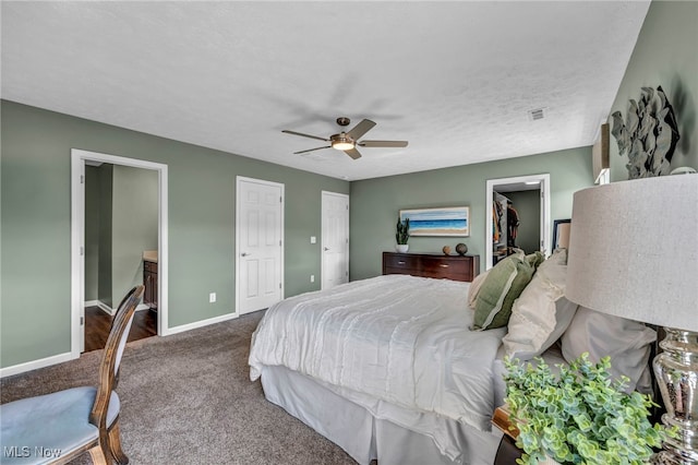 bedroom featuring visible vents, baseboards, a ceiling fan, ensuite bathroom, and carpet