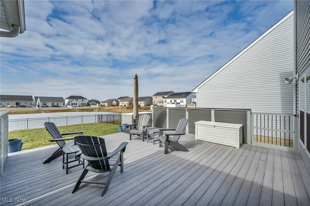 wooden deck with a yard, a residential view, and fence