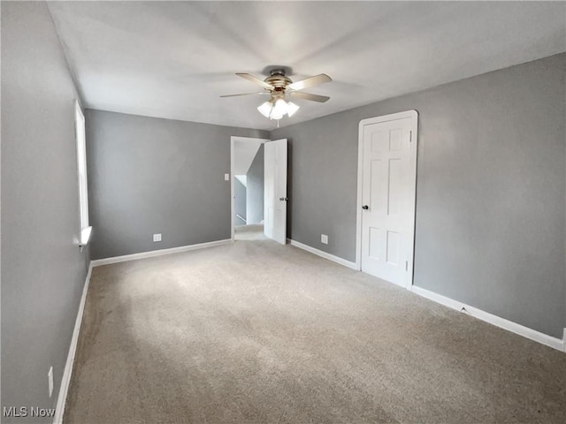 unfurnished bedroom with a ceiling fan, carpet, and baseboards