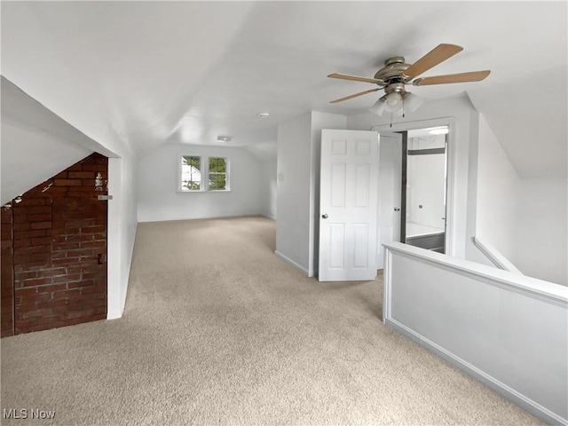 additional living space with vaulted ceiling, carpet flooring, and baseboards