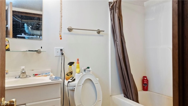 bathroom featuring vanity, toilet, and shower / bath combo with shower curtain