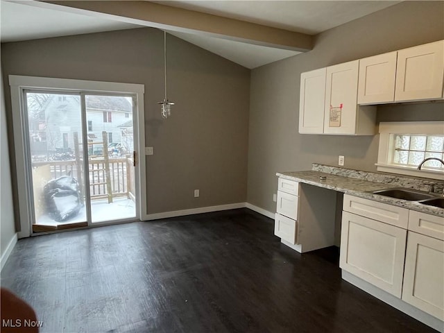 kitchen featuring lofted ceiling with beams, dark wood-style floors, white cabinetry, and a sink