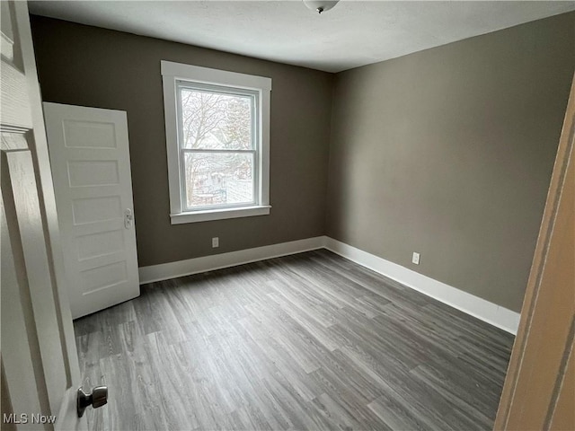 interior space with dark wood-style flooring and baseboards