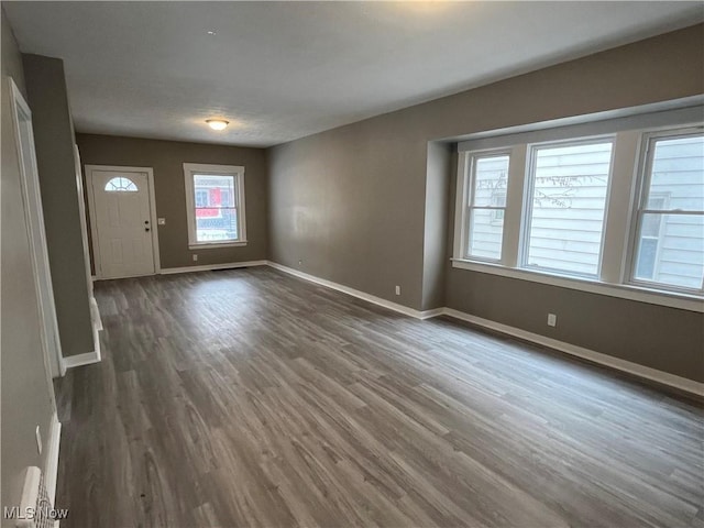 interior space with dark wood finished floors and baseboards