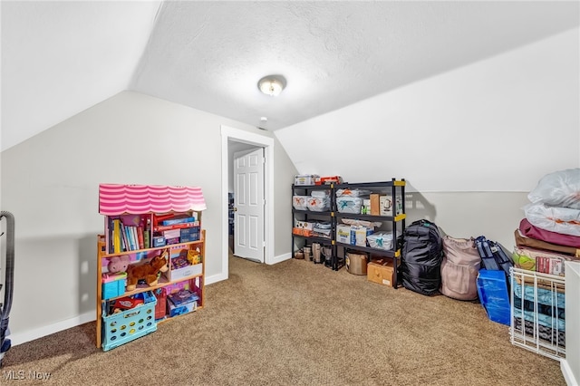 rec room with vaulted ceiling, a textured ceiling, and carpet