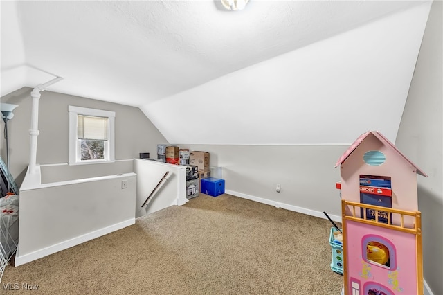 playroom featuring carpet flooring, vaulted ceiling, and baseboards