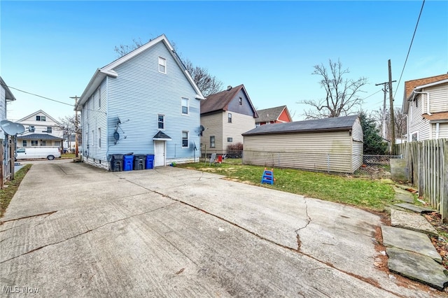 back of property featuring fence