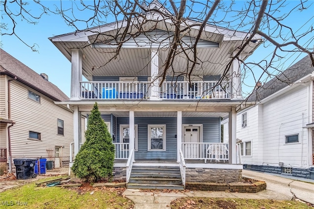 view of front of property featuring a balcony and a porch