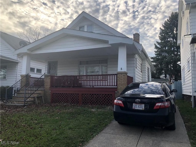 view of front of property featuring covered porch and a chimney